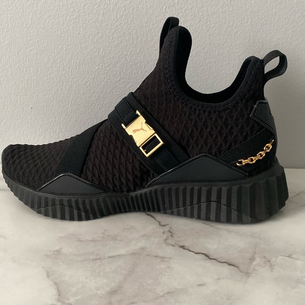 Puma Black shoes w/gold hardware. Women’s Defy Mid-Top training shoe.